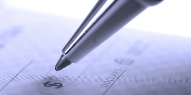 7572745 – person writing check with pen and checkbook