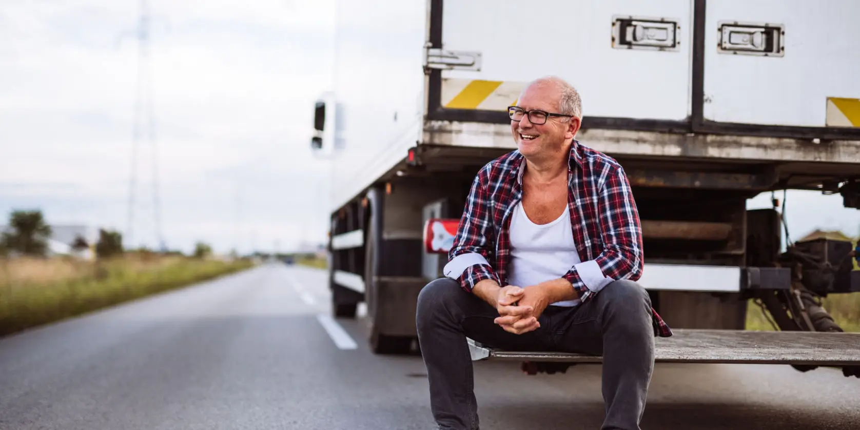 63085345 – senior truck driver posing next to his truck.